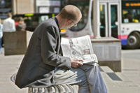 Man reading a newspaper on IFSD's Argyle Street
